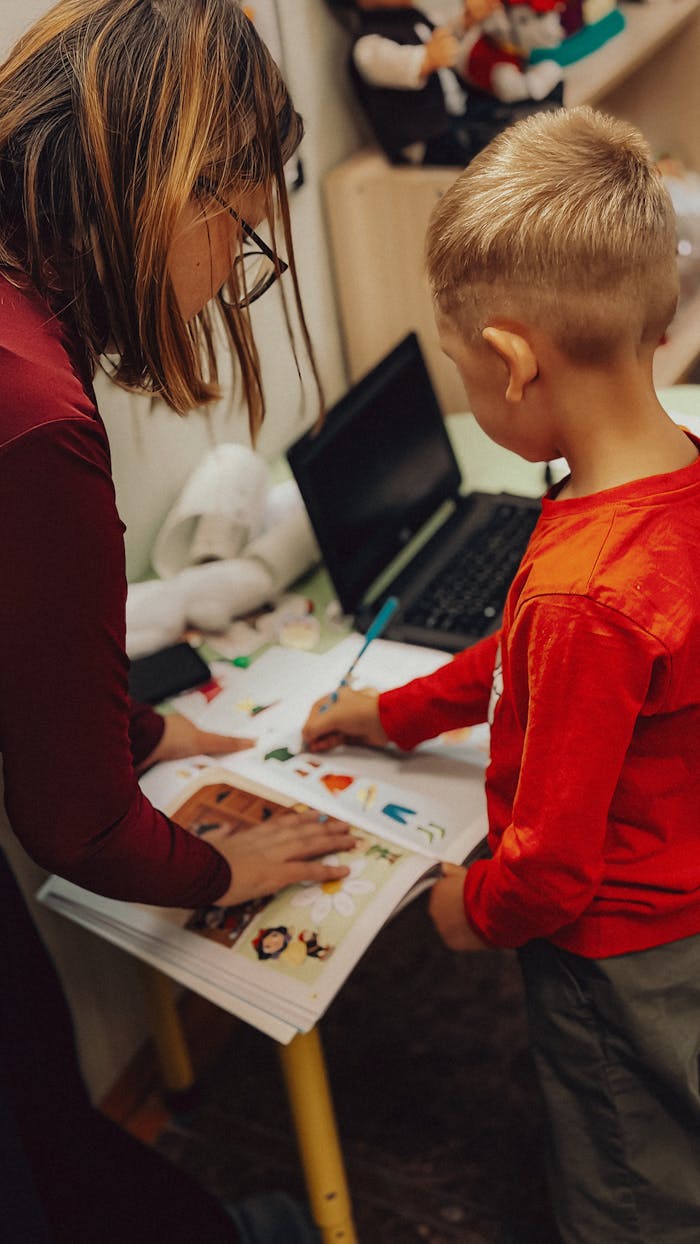 why-choose-us Teacher assisting a child with educational activities in a learning environment.